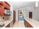 Bright kitchen with granite countertops, stainless steel appliances, and sliding doors to the lanai at 222 Imperial Ridge Ct, Oviedo, FL 32765