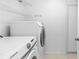Laundry area featuring modern washer and dryer, shelving, and a neutral-toned floor at 222 Imperial Ridge Ct, Oviedo, FL 32765