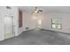 Bright and airy living room offering neutral tones, carpet flooring and easy access to the kitchen at 222 Imperial Ridge Ct, Oviedo, FL 32765