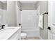 Bright bathroom features a white vanity with quartz countertop and white subway tile shower at 23430 Sw Neptune Blvd, Dunnellon, FL 34431