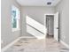 Sunlit bedroom boasts light-colored wood-look tile floors and fresh neutral paint at 23430 Sw Neptune Blvd, Dunnellon, FL 34431