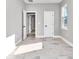 Bright bedroom with light-colored wood-look tile floors and neutral paint offers multiple doorways at 23430 Sw Neptune Blvd, Dunnellon, FL 34431