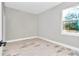 This bedroom is freshly painted and features light-colored wood-look tile floors and ample natural light at 23430 Sw Neptune Blvd, Dunnellon, FL 34431