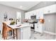 Modern kitchen with white cabinets, quartz countertops, stainless appliances, and open to living area at 23430 Sw Neptune Blvd, Dunnellon, FL 34431
