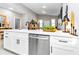 Modern kitchen features stainless steel appliances, white cabinets, and a stylish black faucet at 23430 Sw Neptune Blvd, Dunnellon, FL 34431