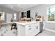 Kitchen island with open living space featuring stainless dishwasher, sink, seating, and modern decor at 23430 Sw Neptune Blvd, Dunnellon, FL 34431