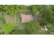 Aerial shot of the house showcasing its mature landscaping, roof, and surrounding greenery at 244 N Leavitt Ave, Orange City, FL 32763
