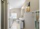 Bright bathroom features a white vanity, toilet, and washer and dryer in an all-in-one space at 244 N Leavitt Ave, Orange City, FL 32763