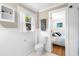 Bright bathroom with a connecting doorway into a bedroom with hardwood floors and neutral bedding at 244 N Leavitt Ave, Orange City, FL 32763