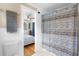 Bright bathroom with a view into a bedroom with hardwood floors and neutral bedding at 244 N Leavitt Ave, Orange City, FL 32763