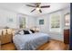 Bright bedroom featuring wood floors, white walls, windows with blinds, and a ceiling fan at 244 N Leavitt Ave, Orange City, FL 32763