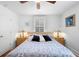 Bedroom with a plush bed with lots of pillows, two side tables with lamps, and two windows at 244 N Leavitt Ave, Orange City, FL 32763