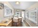 Cozy dining room featuring a round table, wood floors, and natural light from multiple windows at 244 N Leavitt Ave, Orange City, FL 32763
