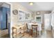 Bright dining area with hardwood floors, table for four, and open view to the adjacent kitchen at 244 N Leavitt Ave, Orange City, FL 32763