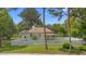 Charming home featuring a well-manicured lawn and a classic white picket fence at 244 N Leavitt Ave, Orange City, FL 32763