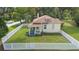 Charming home with a white picket fence and front porch surrounded by lush greenery at 244 N Leavitt Ave, Orange City, FL 32763