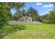 Charming one-story home with a well-manicured lawn and a white picket fence at 244 N Leavitt Ave, Orange City, FL 32763