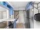 Well-equipped kitchen with stainless steel appliances, wood floors, and a barn door to the stairway at 244 N Leavitt Ave, Orange City, FL 32763