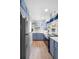 Efficient kitchen with modern stainless steel appliances, wood floors and bright lighting at 244 N Leavitt Ave, Orange City, FL 32763