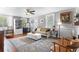 Inviting living room with hardwood floors, large rug, and natural light from multiple windows at 244 N Leavitt Ave, Orange City, FL 32763
