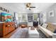 Cozy living room featuring hardwood floors, stylish furnishings, and plenty of natural light at 244 N Leavitt Ave, Orange City, FL 32763