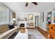 Open living room with hardwood floors, decorative fireplace, and sliding barn door to the adjacent room at 244 N Leavitt Ave, Orange City, FL 32763