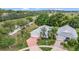 Aerial view showcases home with palm trees, brick driveway, and beautiful landscaping at 2500 Castle Pines St, Clermont, FL 34711