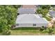 An aerial view of the property showing the roof, screened-in porch, and surrounding yard at 2500 Castle Pines St, Clermont, FL 34711