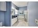 Blue bathroom features a shower, tub, and vanity at 2500 Castle Pines St, Clermont, FL 34711