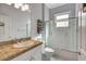 Bright bathroom features a shower, vanity, and a window at 2500 Castle Pines St, Clermont, FL 34711