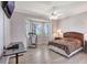 Bright bedroom features a ceiling fan, bay windows, and wood-look floors at 2500 Castle Pines St, Clermont, FL 34711