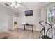 Bright bedroom features wood-look floors and a ceiling fan at 2500 Castle Pines St, Clermont, FL 34711