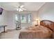 Serene bedroom featuring a bay window, hardwood floors, and minimalist decor at 2500 Castle Pines St, Clermont, FL 34711