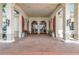 Covered entryway featuring arched doors, decorative shutters, and potted plants at 2500 Castle Pines St, Clermont, FL 34711