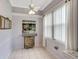 Bright dining room featuring tile flooring, a ceiling fan, and natural light from the large window at 2500 Castle Pines St, Clermont, FL 34711