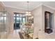 Elegant dining room with modern decor, glass table, and access to outdoor views at 2500 Castle Pines St, Clermont, FL 34711