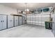 Spacious garage with ample storage cabinets, shelving, and a clean epoxy floor at 2500 Castle Pines St, Clermont, FL 34711