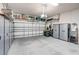 Clean and spacious garage with ample storage space, epoxy floors, and an automatic garage door at 2500 Castle Pines St, Clermont, FL 34711