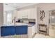 Modern kitchen with white cabinets, blue countertops, and stylish bar seating at 2500 Castle Pines St, Clermont, FL 34711