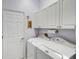 Laundry room features a washer, dryer, and storage at 2500 Castle Pines St, Clermont, FL 34711
