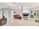 Bright living room featuring tile floors, modern lighting, and stylish furnishings, adjacent to the kitchen area at 2500 Castle Pines St, Clermont, FL 34711
