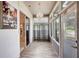 Enclosed sunroom filled with natural light, featuring wood look flooring and multiple windows at 2500 Castle Pines St, Clermont, FL 34711
