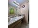 Well-lit bathroom featuring a single sink, and peach walls at 2765 Montego Bay Blvd, Kissimmee, FL 34746