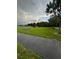 Community park with walking path and playground surrounded by lush green space at 2765 Montego Bay Blvd, Kissimmee, FL 34746