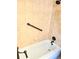Clean bathroom featuring a tub with bronze fixtures and safety handles at 2947 S Atlantic Ave # 601, Daytona Beach, FL 32118