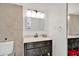 Neutrally-toned bathroom with a vanity, decorative mirror, and a functional toilet at 2947 S Atlantic Ave # 601, Daytona Beach, FL 32118