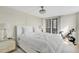 Restful bedroom features minimalist decor, comfortable bed, and city views with a stationary bicycle at 2947 S Atlantic Ave # 601, Daytona Beach, FL 32118