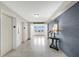 Hallway area with tiled floors, elevators, and a decoratively-adorned side table at 2947 S Atlantic Ave # 601, Daytona Beach, FL 32118