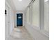 Bright hallway with large windows and a blue door that welcomes beach vibes at 2947 S Atlantic Ave # 601, Daytona Beach, FL 32118