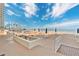 Outdoor deck with ocean views, lounge chairs, and dining tables under the clear sky at 2947 S Atlantic Ave # 601, Daytona Beach, FL 32118